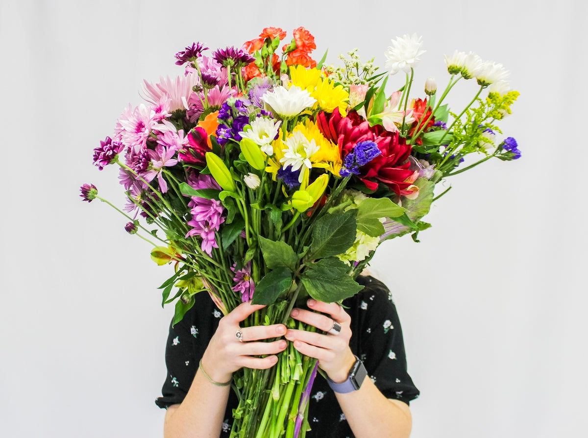 person holding bouquet of flowers