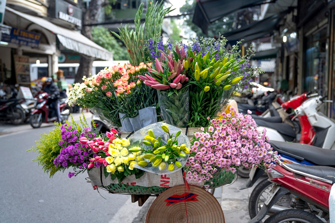 a bunch of flowers that are sitting on a bike