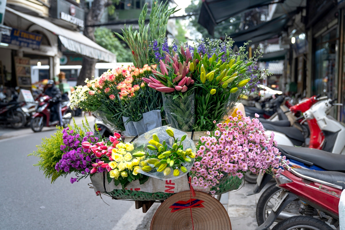 a bunch of flowers that are sitting on a bike