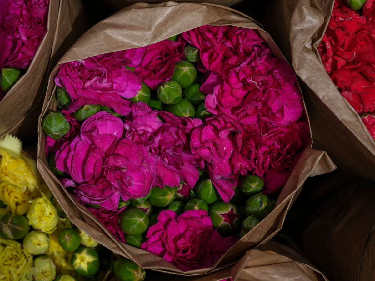 A bunch of bags filled with lots of flowers