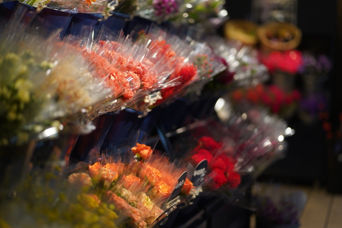 Bundles of colorful flowers wrapped in plastic