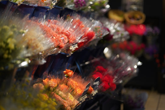 Bundles of colorful flowers wrapped in plastic