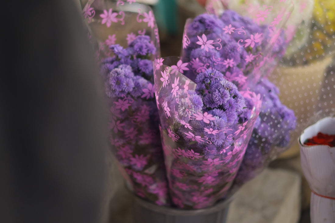 Bouquets of small purple flowers wrapped in plastic