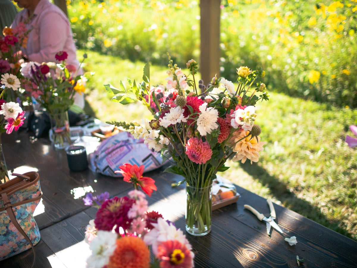 Bouquets of colorful flowers arranged on a table outdoors