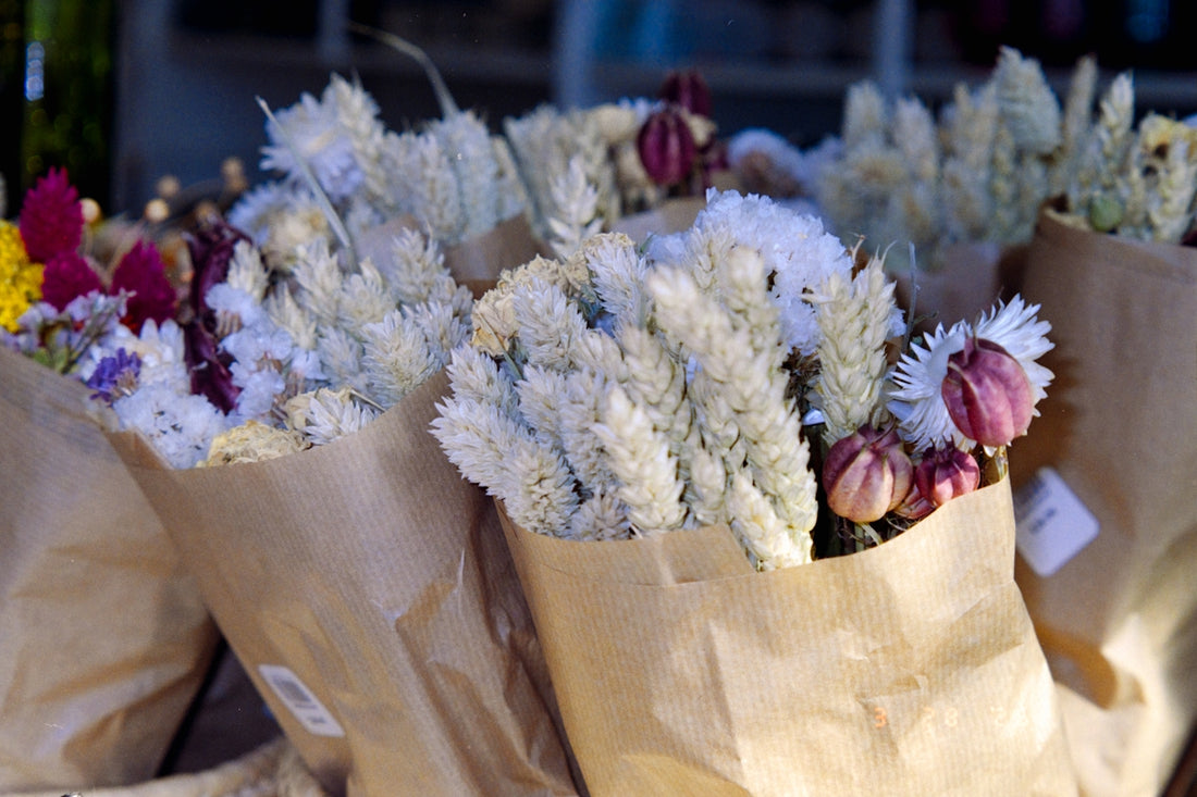 Bouquets of dried flowers wrapped in brown paper