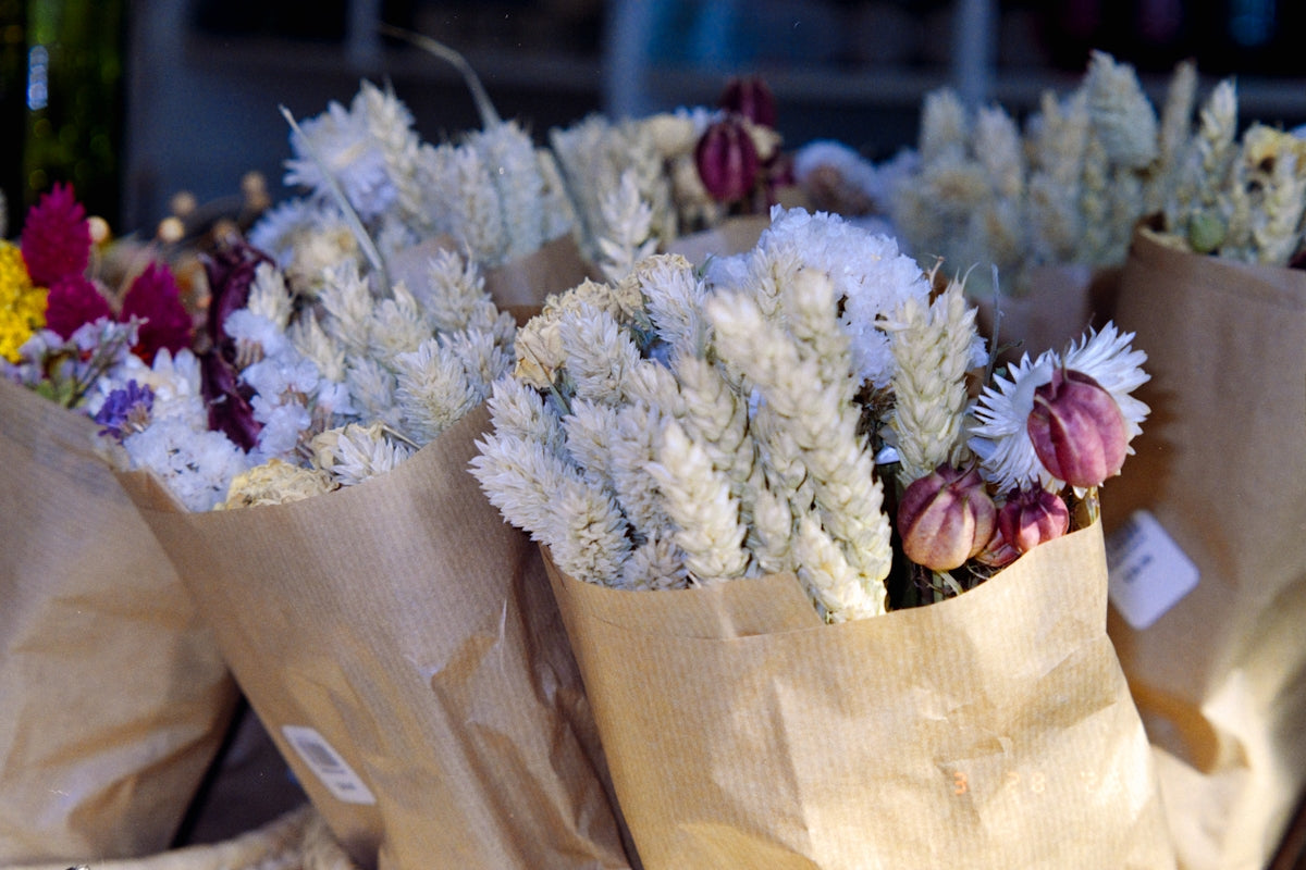 Bouquets of dried flowers wrapped in brown paper